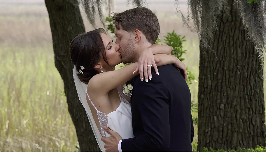 Intimate wedding photography of a newlywed couple sharing a kiss